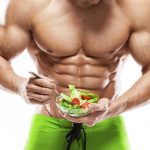 Shaped and healthy body man holding a fresh salad bowl,shaped abdominal, isolated on white background, colored retouched
